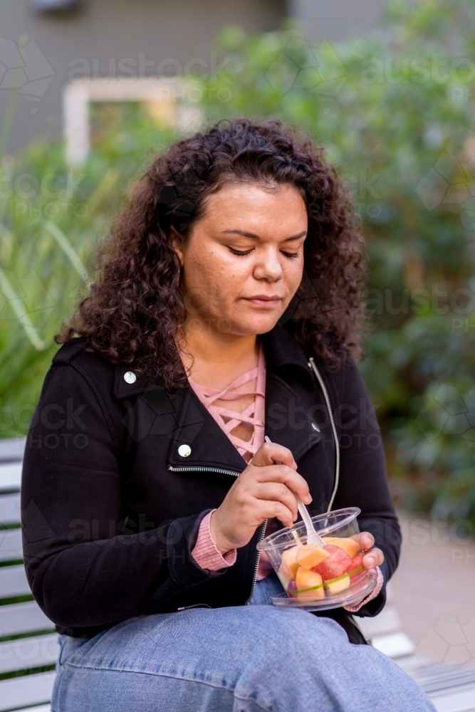 woman eating fruit salad - Australian Stock Image