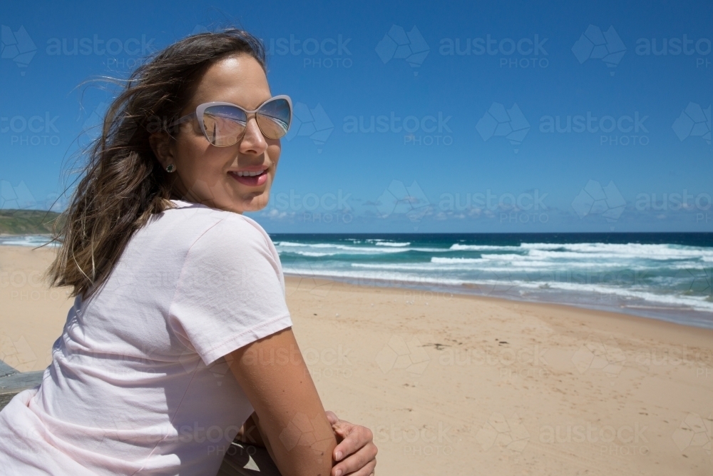Woman enjoying summer sun at the beach - Australian Stock Image