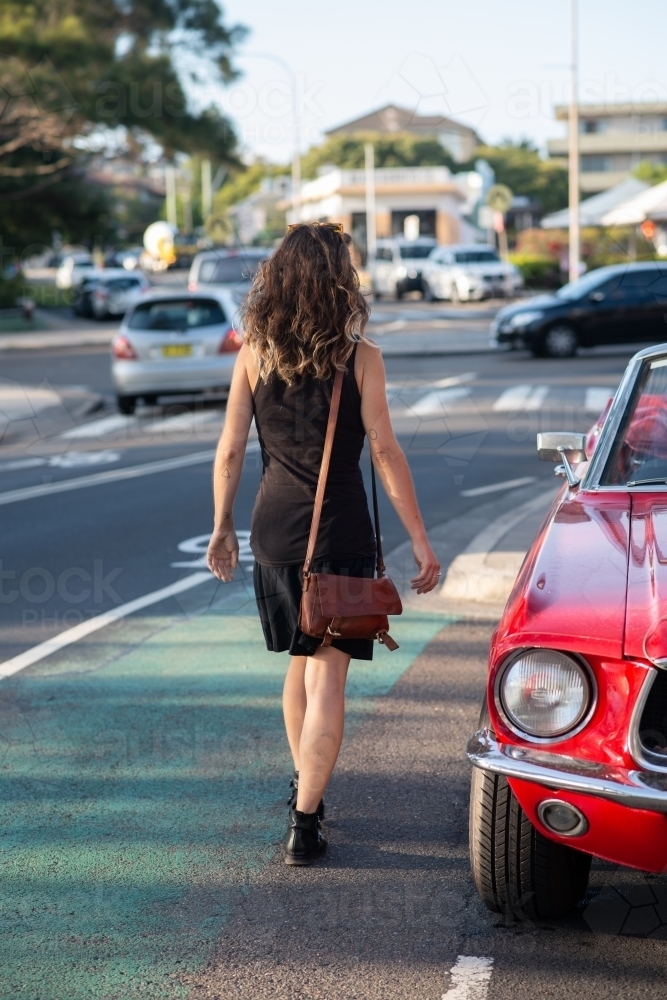 woman getting into classic car - Australian Stock Image
