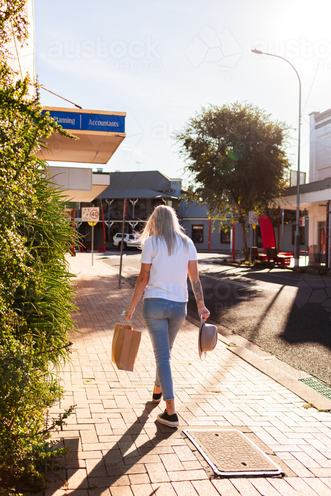 image-of-woman-going-shopping-down-street-walking-past-financial