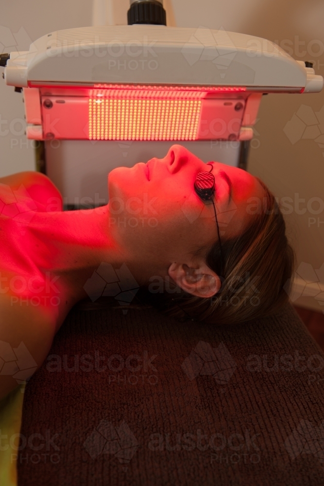 woman having beauty light therapy session, red light - Australian Stock Image
