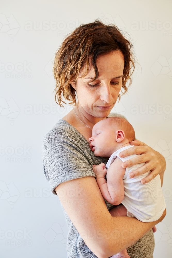 Woman holding newborn baby - Australian Stock Image