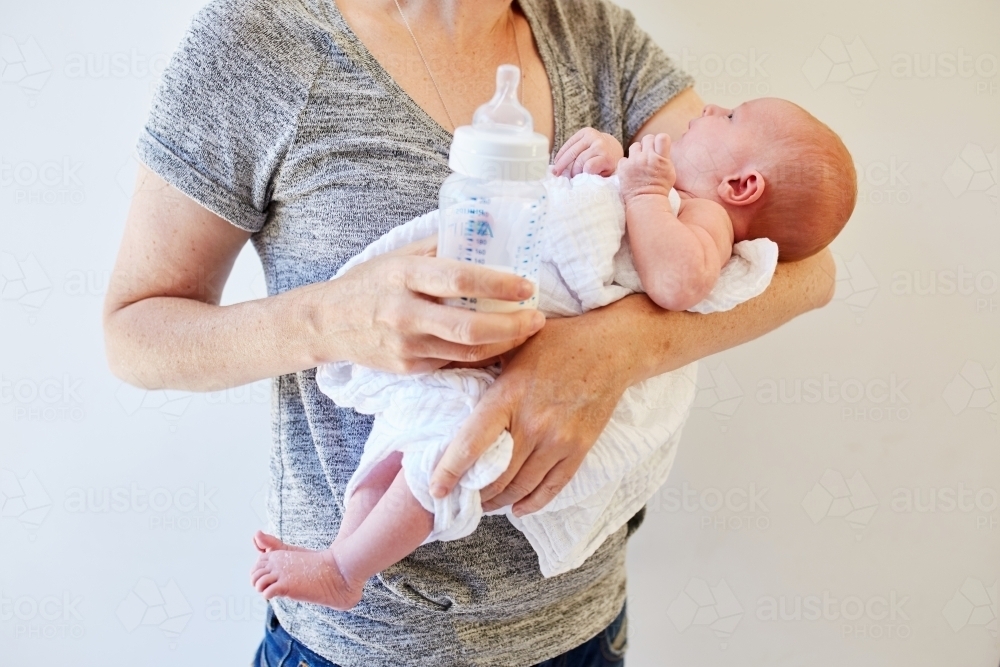 Woman holding newborn baby - Australian Stock Image