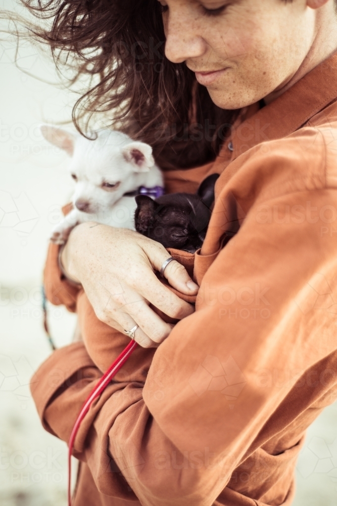Woman holding small dogs - Australian Stock Image