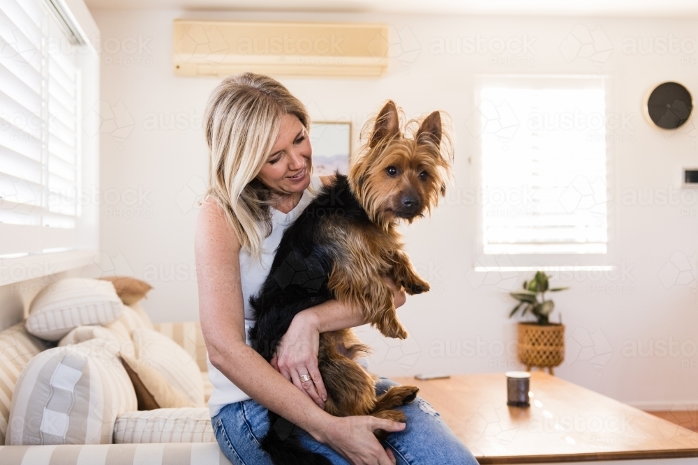 Image of woman hugging her dog - Austockphoto