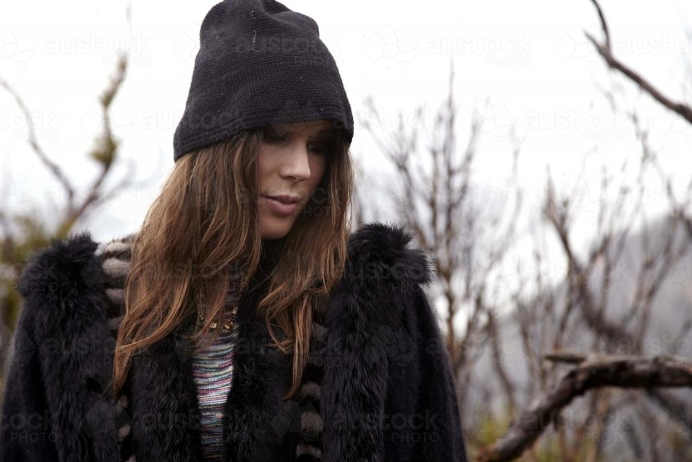 Woman in beanie looking down - Australian Stock Image