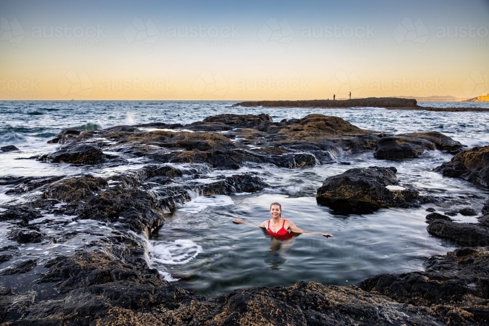 Woman in coastal rock pool - Australian Stock Image
