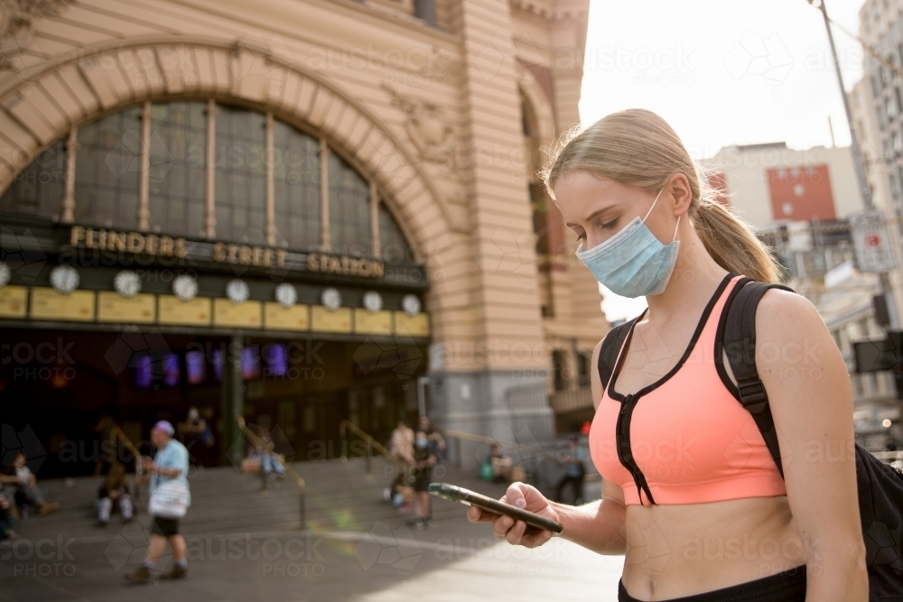 Woman in Face Mask Waiting at Flinders Street Station - Australian Stock Image