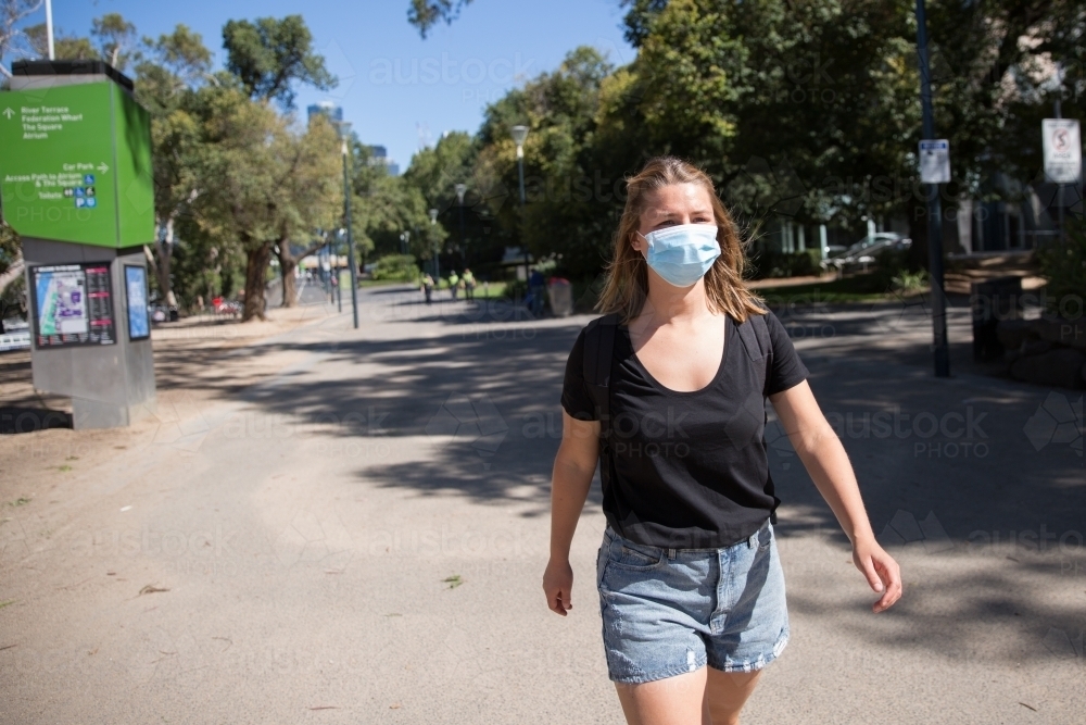 Woman in Face Mask Walking By Yarra River - Australian Stock Image