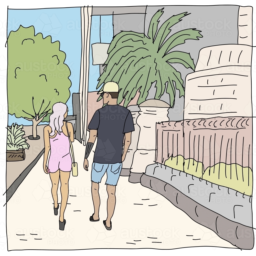 Woman in pink jumpsuit, man in black t-shirt and denim shorts walking on footpath past buildings - Australian Stock Image