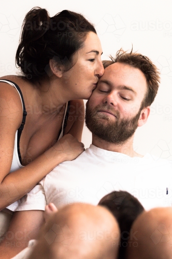 Woman kissing man - Australian Stock Image
