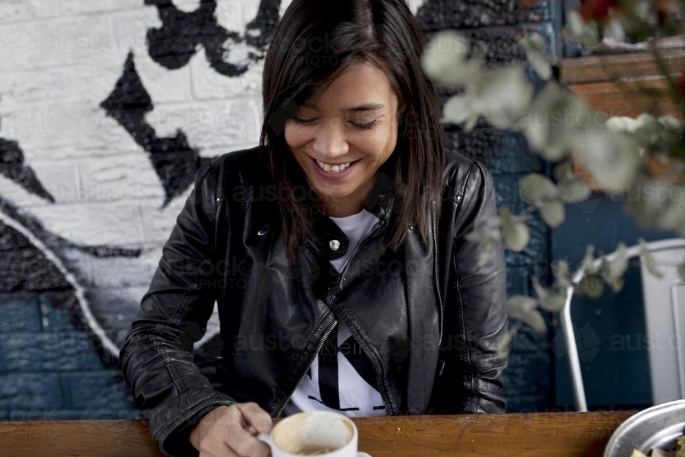 Woman laughing at a cafe - Australian Stock Image