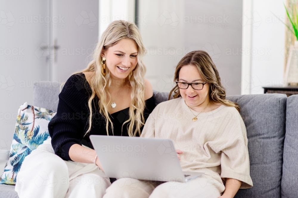 woman laughing at something on laptop - Australian Stock Image