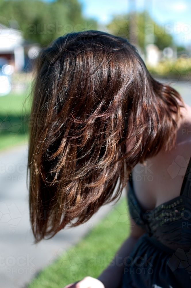 Woman leaning forward with long hair - Australian Stock Image