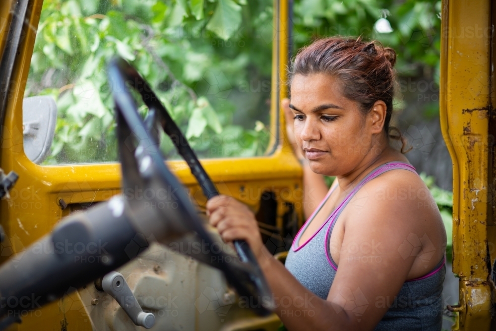 Woman looking in an the drivers door of an old landcruiser - Australian Stock Image