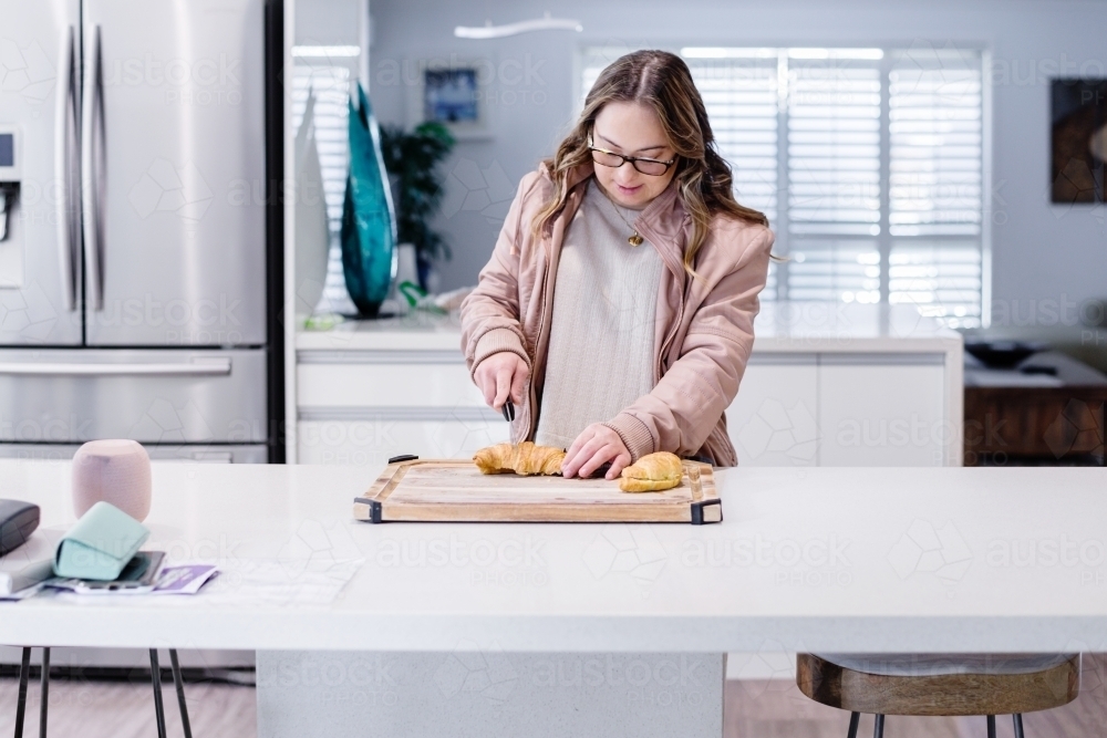 woman making breakfast, from a series feat. a Down Syndrome woman - Australian Stock Image