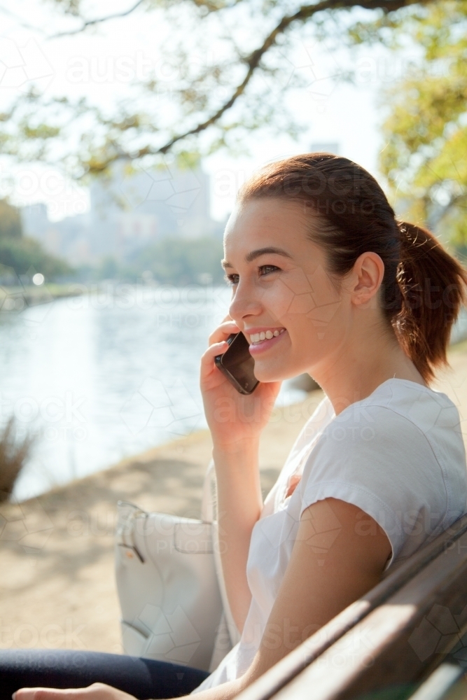 Woman on the Phone by the Yarra - Australian Stock Image