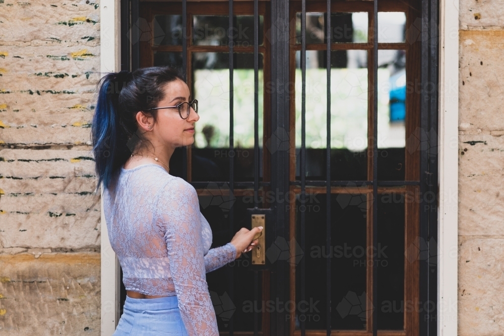 woman opening door - Australian Stock Image