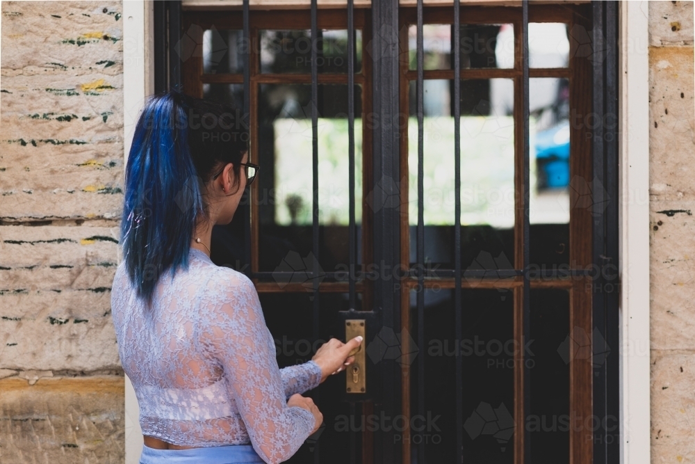 woman opening door - Australian Stock Image