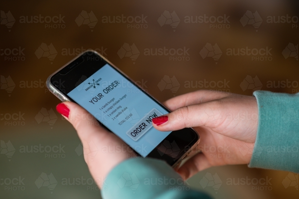 woman ordering takeaway food online - Australian Stock Image