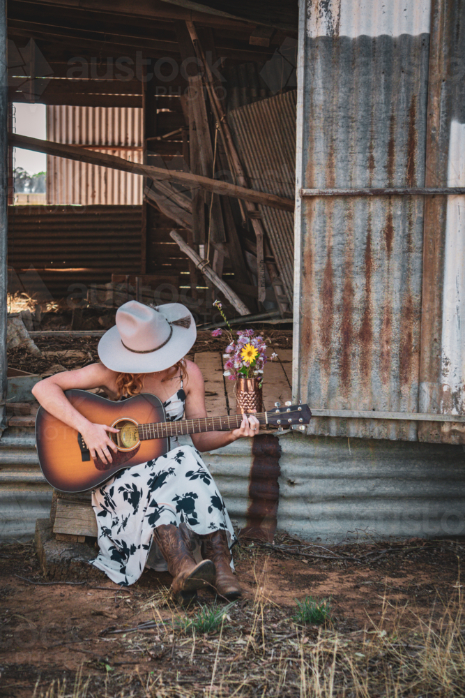 Woman playing a guitar - Australian Stock Image