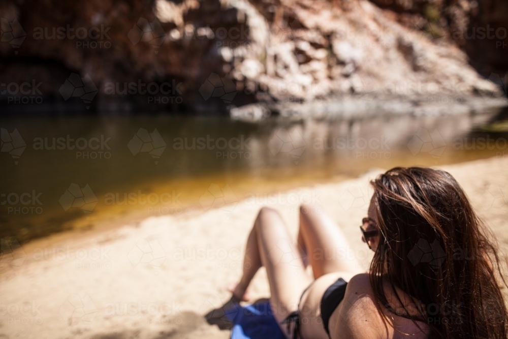 Woman relaxing at swimming hole - Australian Stock Image