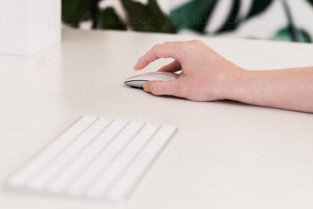 Image of woman's hand on a mouse - Austockphoto