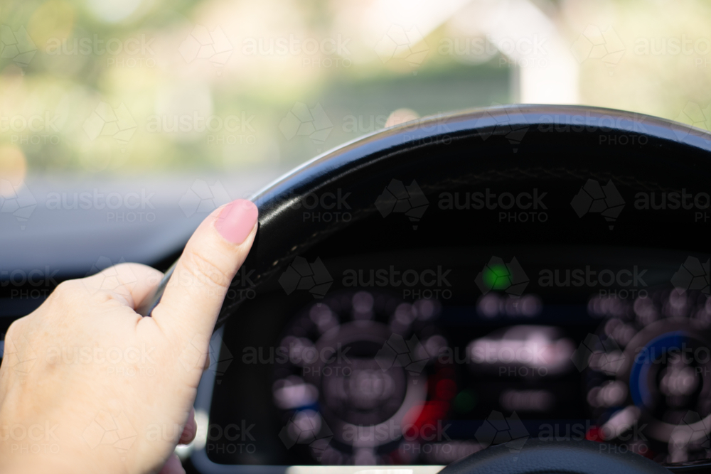 woman's hand on steering wheel - Australian Stock Image