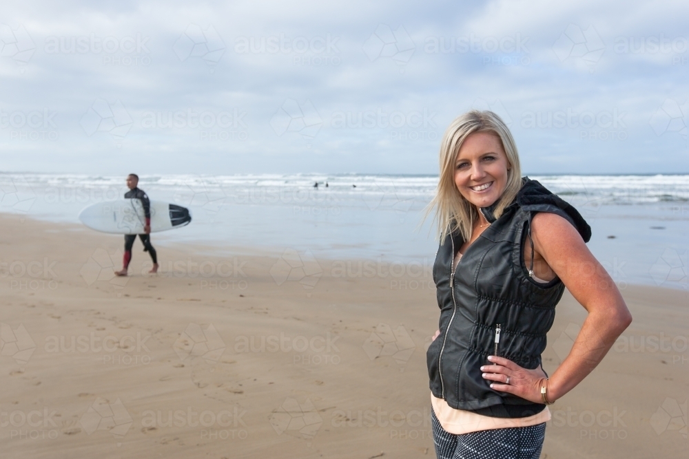 woman standing on hands and hips on the beach - Australian Stock Image