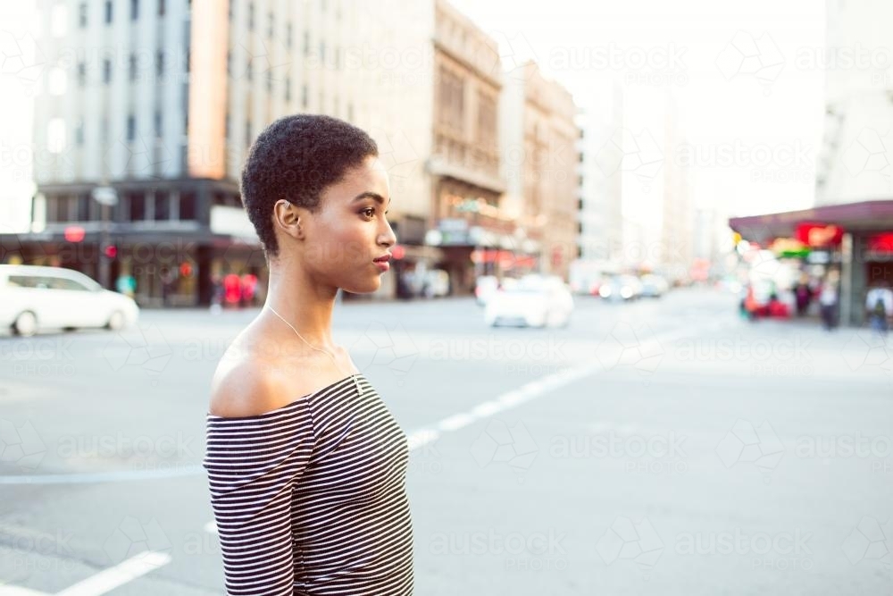 Woman standing on the street in the city - Australian Stock Image
