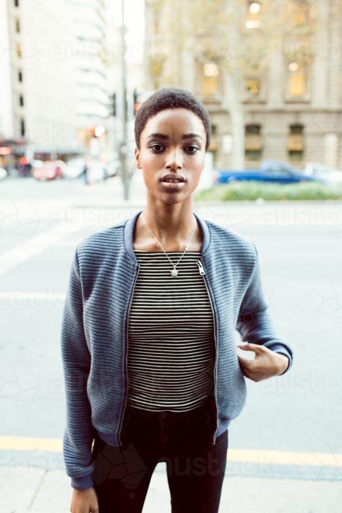 Woman standing on the street in the city - Australian Stock Image