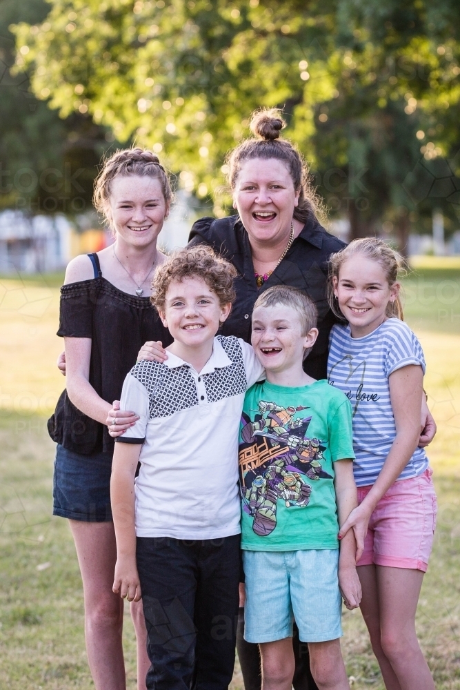 Woman standing with children laughing - Australian Stock Image