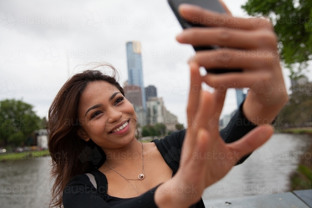 Woman taking a selfie by the Yarra - Australian Stock Image