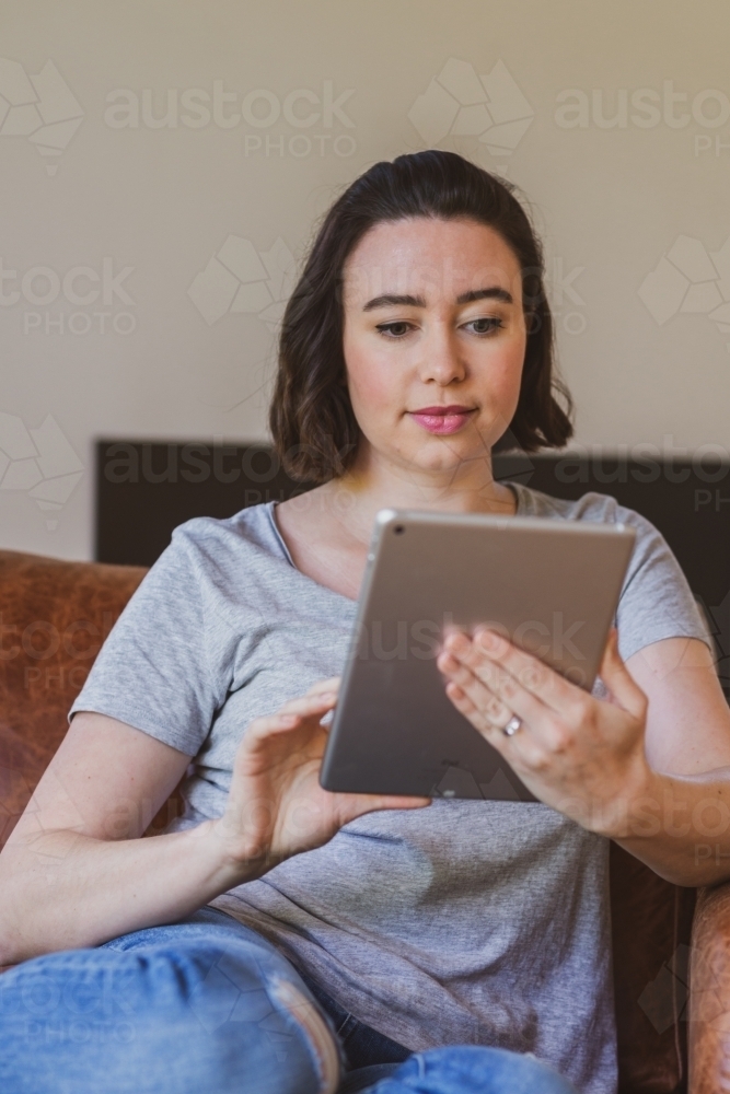 Image of woman using computer at home - Austockphoto