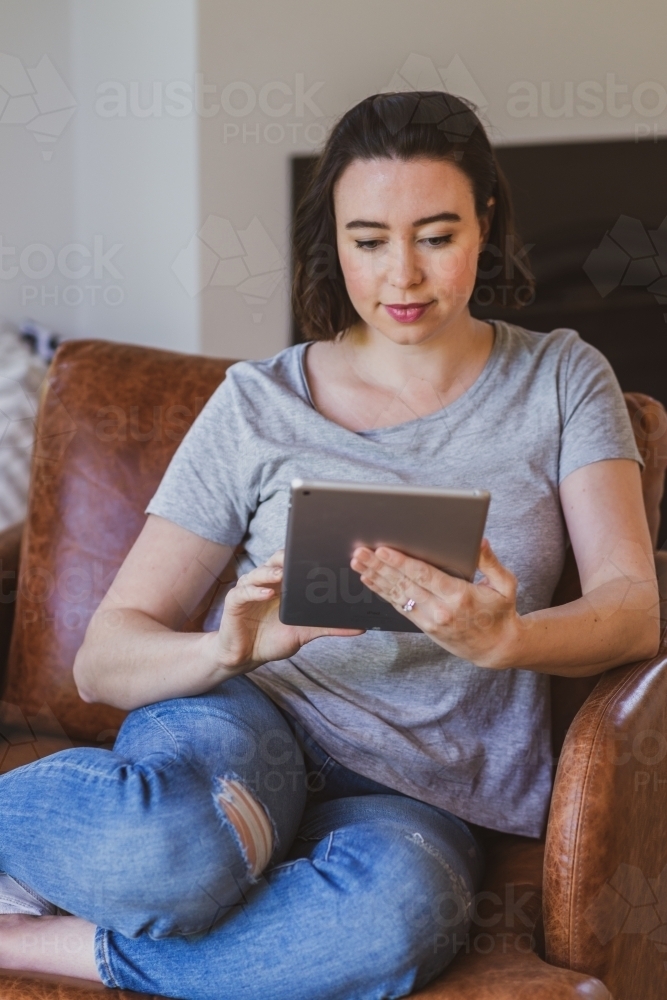 woman using computer at home - Australian Stock Image