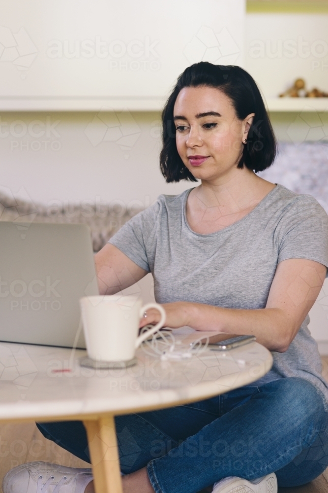 woman using laptop at home - Australian Stock Image
