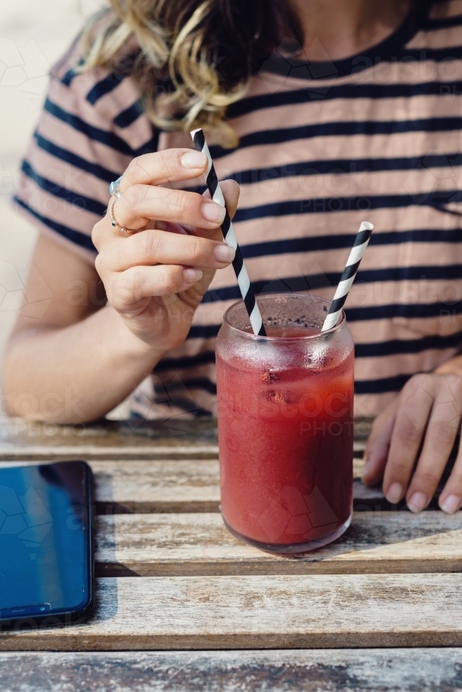 Image of woman using paper straw - Austockphoto