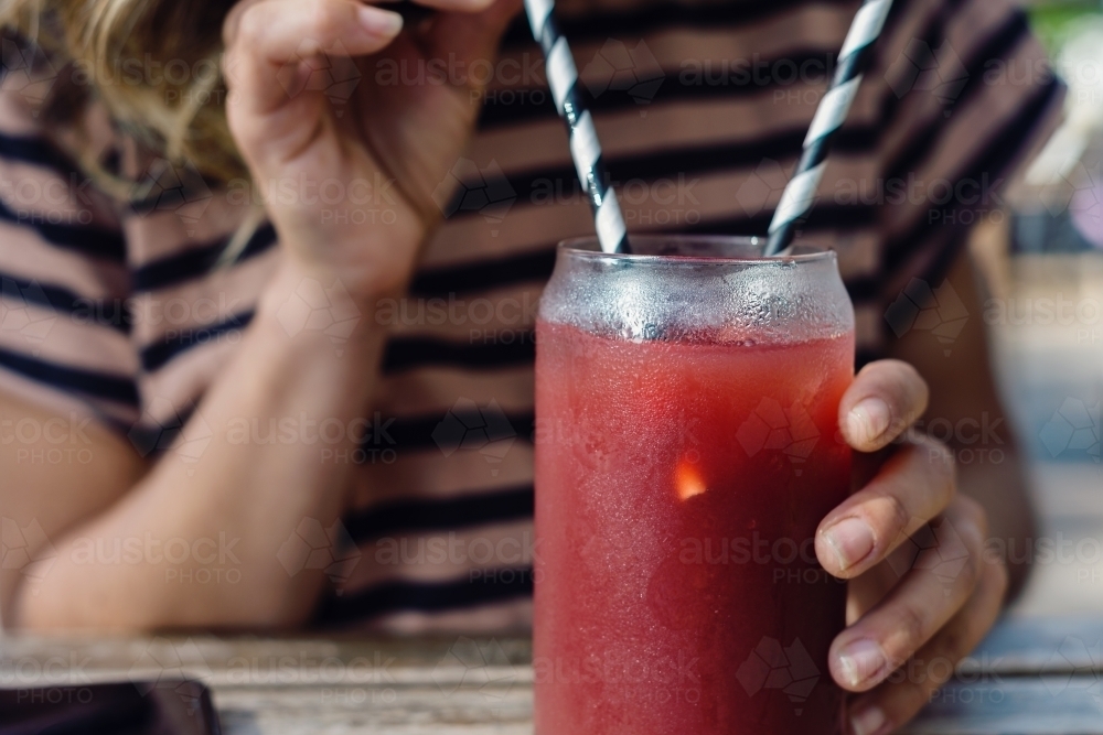 woman using paper straw - Australian Stock Image