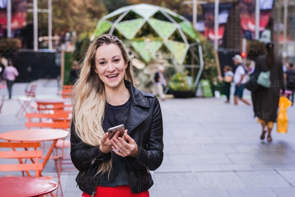 woman using phone in the city - Australian Stock Image