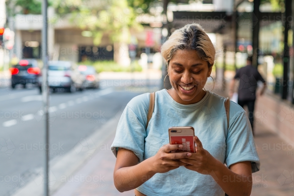 woman using phone in the city - Australian Stock Image
