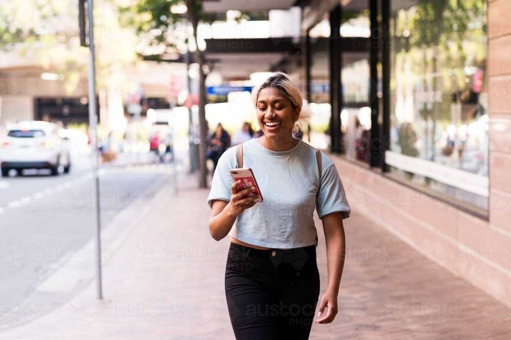 woman using phone in the street - Australian Stock Image