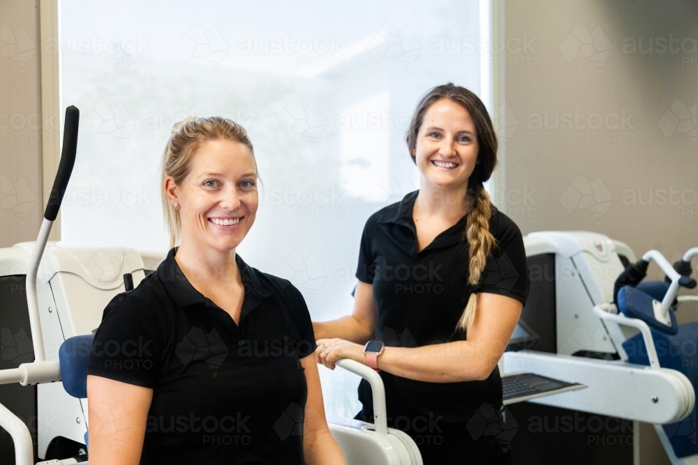 Woman using rehabilitation exercise machine - Australian Stock Image