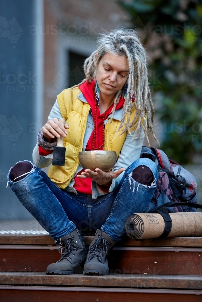 Woman using Tibetan singing bowl - Australian Stock Image