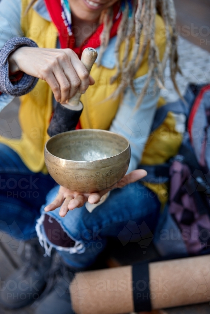 Woman using Tibetan singing bowl - Australian Stock Image