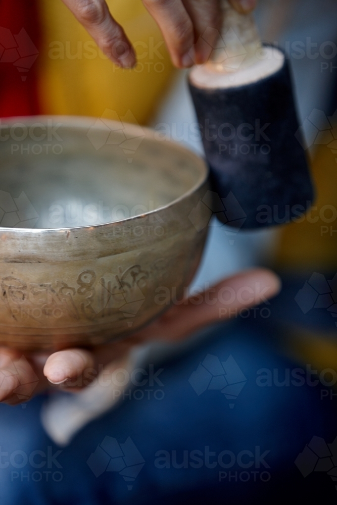 Woman using Tibetan singing bowl - Australian Stock Image