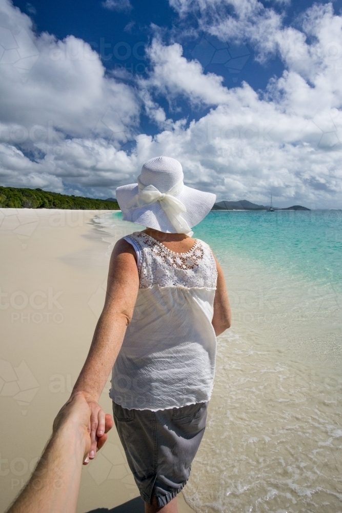 Woman walking along Whitehaven Beach - Australian Stock Image