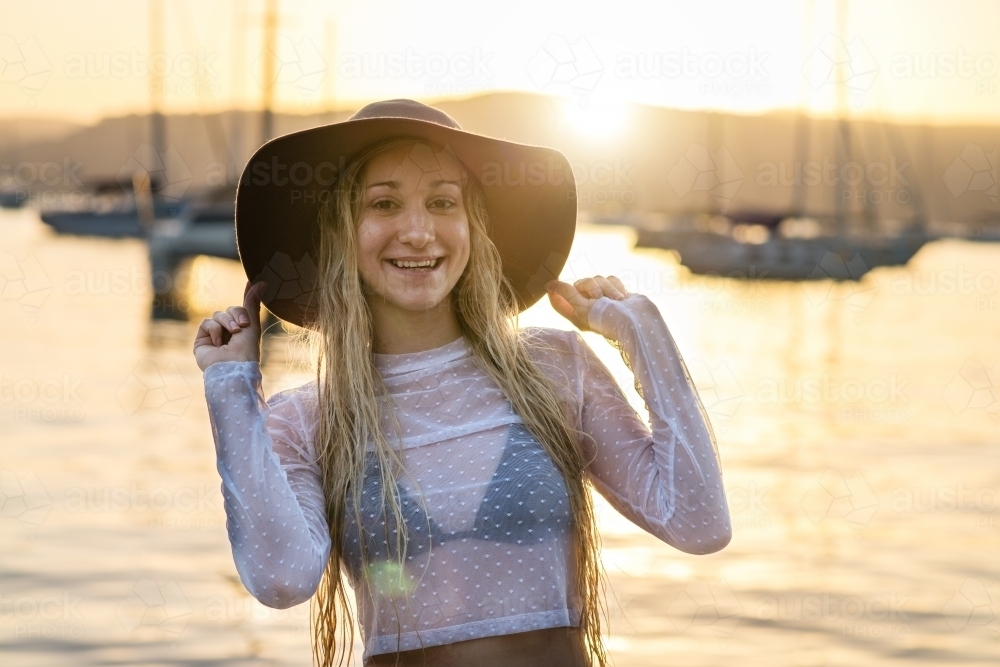 woman wearing hat in the afternoon sun - Australian Stock Image