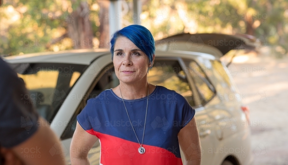 Woman with blue hair in front of a car - Australian Stock Image