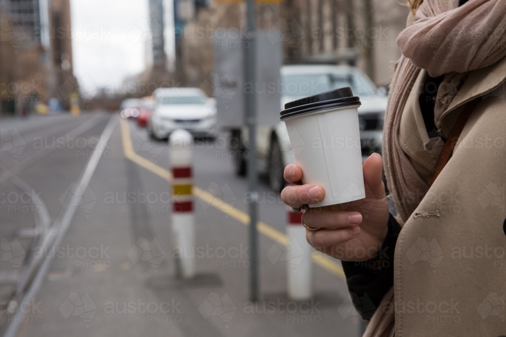 Woman with Coffee Waiting for Tram - Australian Stock Image