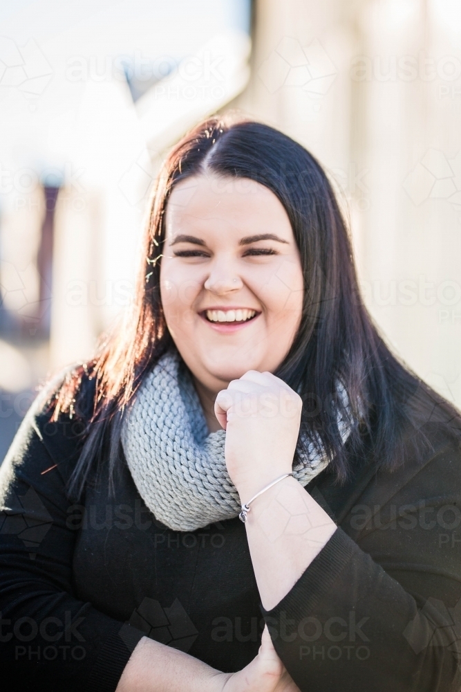Woman with long dark hair laughing - Australian Stock Image